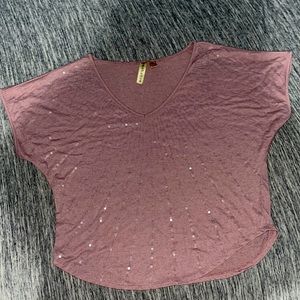 This is a Light purple shirt with sequence it’s in the size large